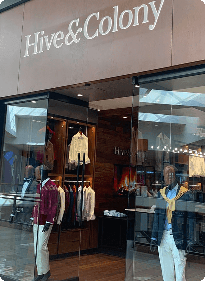 Hive & Colony storefront with mannequins in colorful outfits.